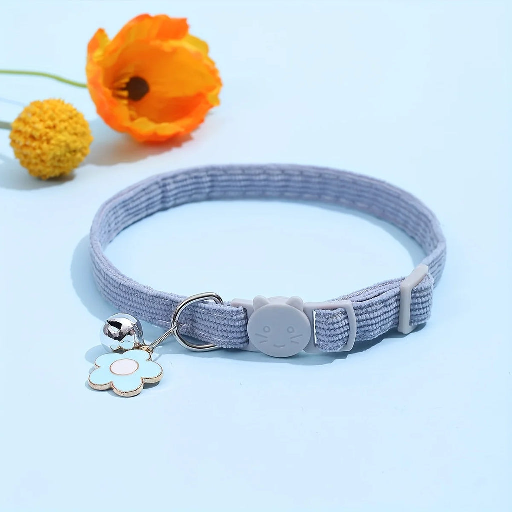 Collier gris avec deux charmes sur fond bleu clair

