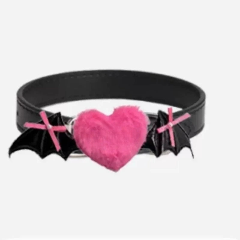 Ras-du-cou noir avec un cœur rose et des ailes de chauve-souris sur fond blanc

