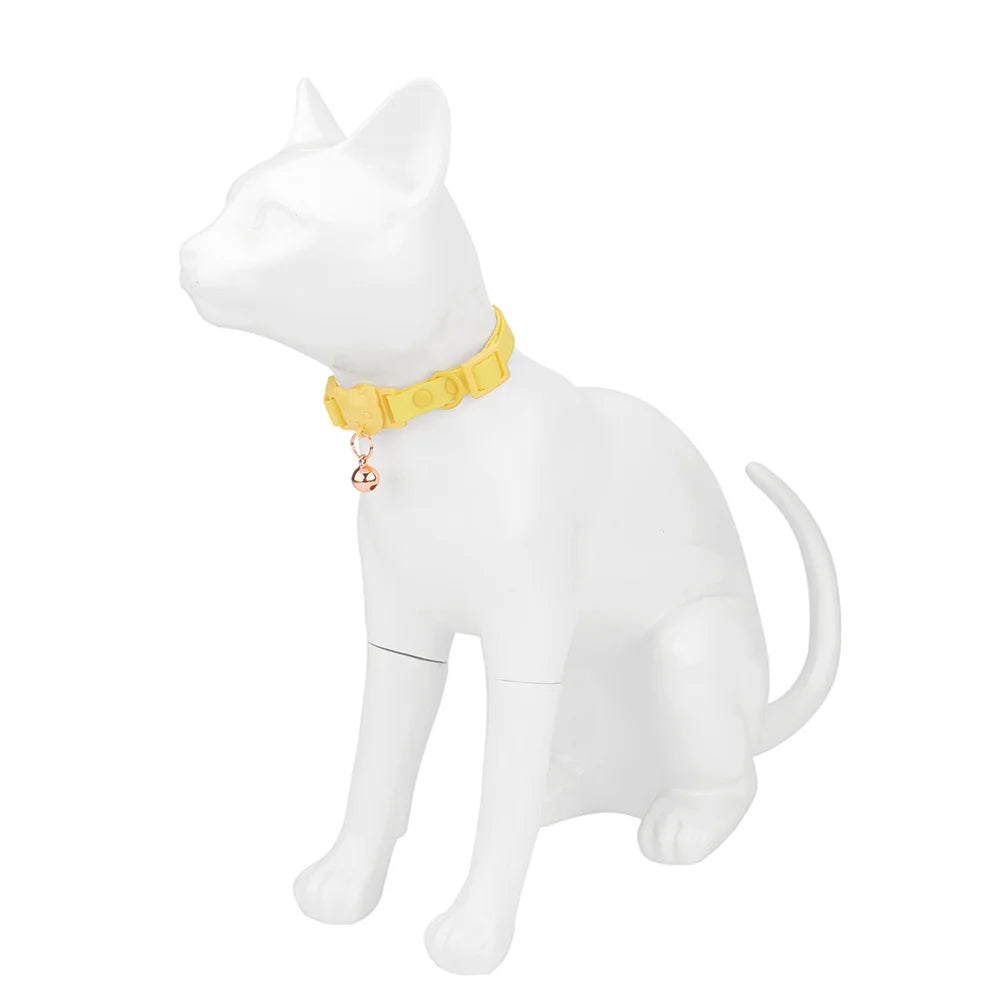 Figurine de chat blanche avec un collier jaune sur fond blanc

