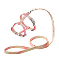 Harnais et laisse pour animal avec un motif tie-dye rose et jaune sur fond blanc

